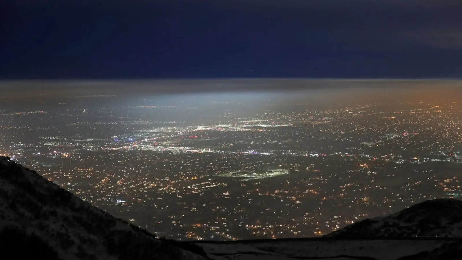 Salt Lake City valley at night time with a cloud of haze