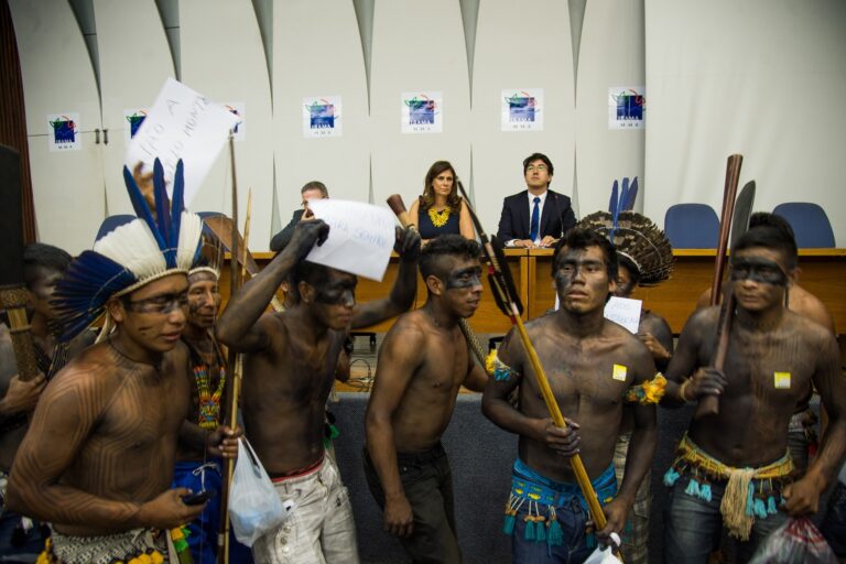 Indigenous representatives protest against Belo Monte during a November 2015 press conference of Marilene Ramos, then president of Brazil’s environmental agency, IBAMA. Indigenous organizations repeatedly warned of social and ecological damage caused by the power plant.