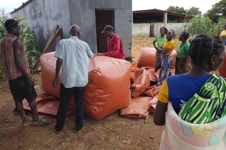 Biogas is filled into portable storage bags for distribution to households located farther from the central digester in Nkhundye village. Image courtesy of Biogas Technology in Zambia.