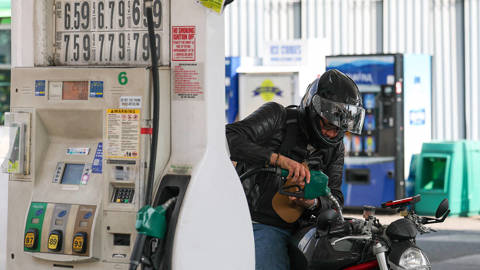 Man fills up a motorcycle with gasoline at a gas station in Manhattan, New York, as rising fuel prices linked to Middle East conflict push up inflation expectations in the United States.