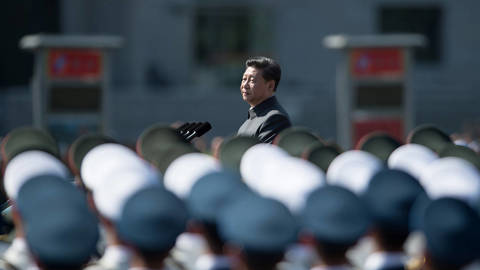 Chinese President Xi Jinping inspects People’s Liberation Army troops during the 2015 Victory Day military parade in Beijing, demonstrating military strength and centralized state authority.