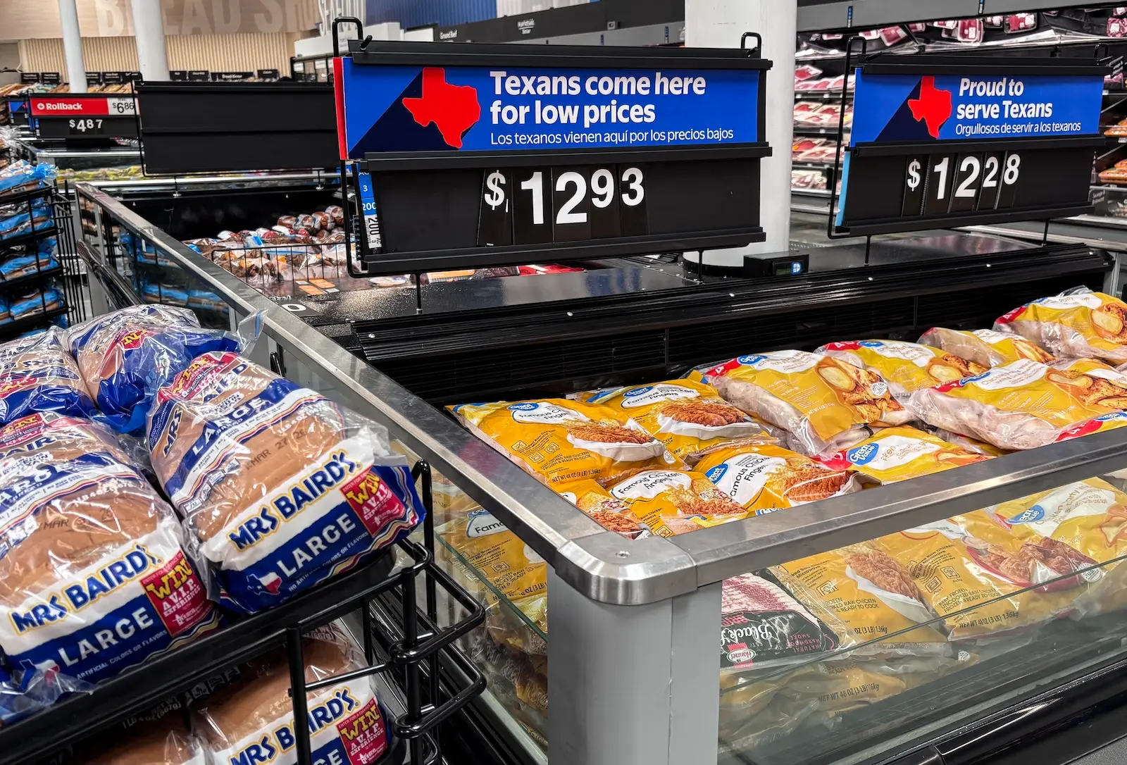 packages of chicken fingers at a supermarket in Texas, with a sign